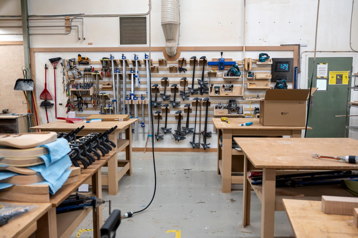 a wall of wood working tools stands inside the woodshop at maker cube in langley city