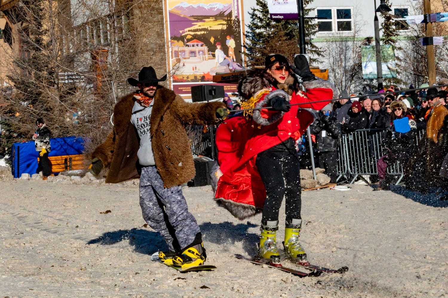 two skijoring athletes being towed by a rope behind a horse