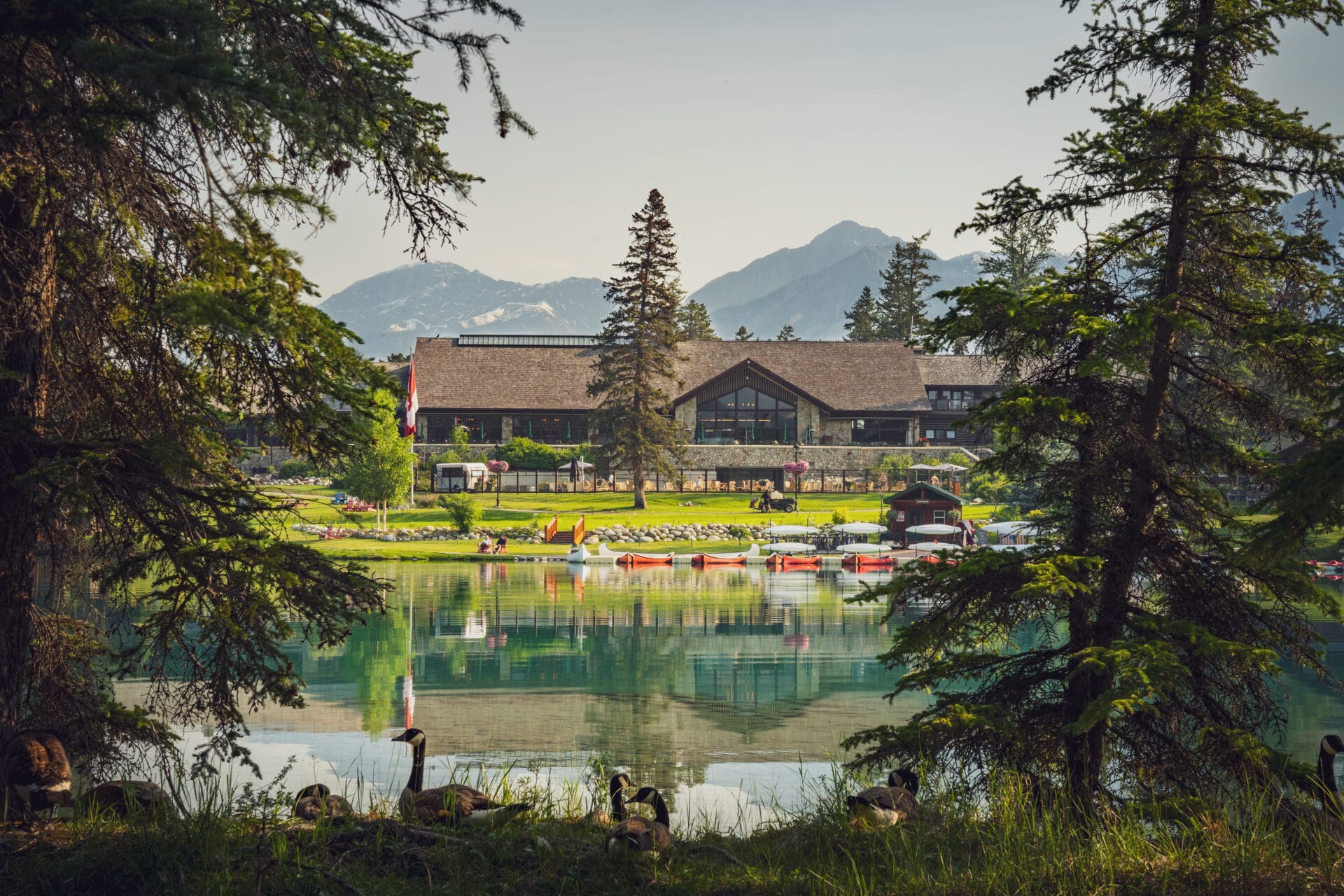 view of jasper park lodge from a distance across a lake