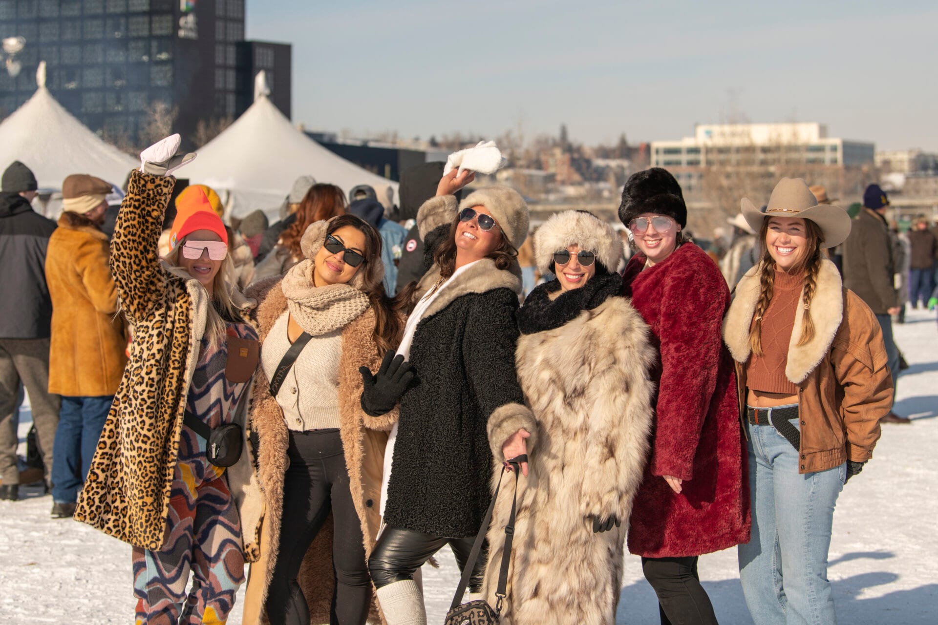 a group of people wearing their best western wear at the skijor event in calgary