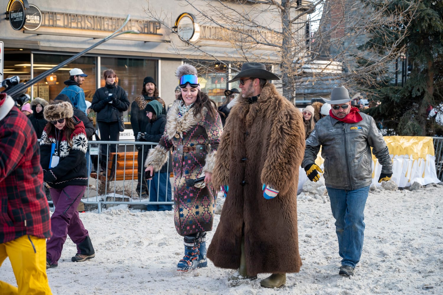 a man wears a long fluffy fur coat at a skijoring event at the banff snowdays festival