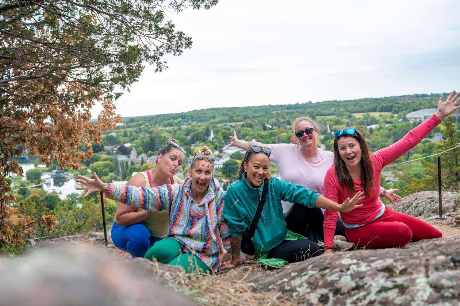 group of five women at the top of Foley Mountain hike in westport ontario