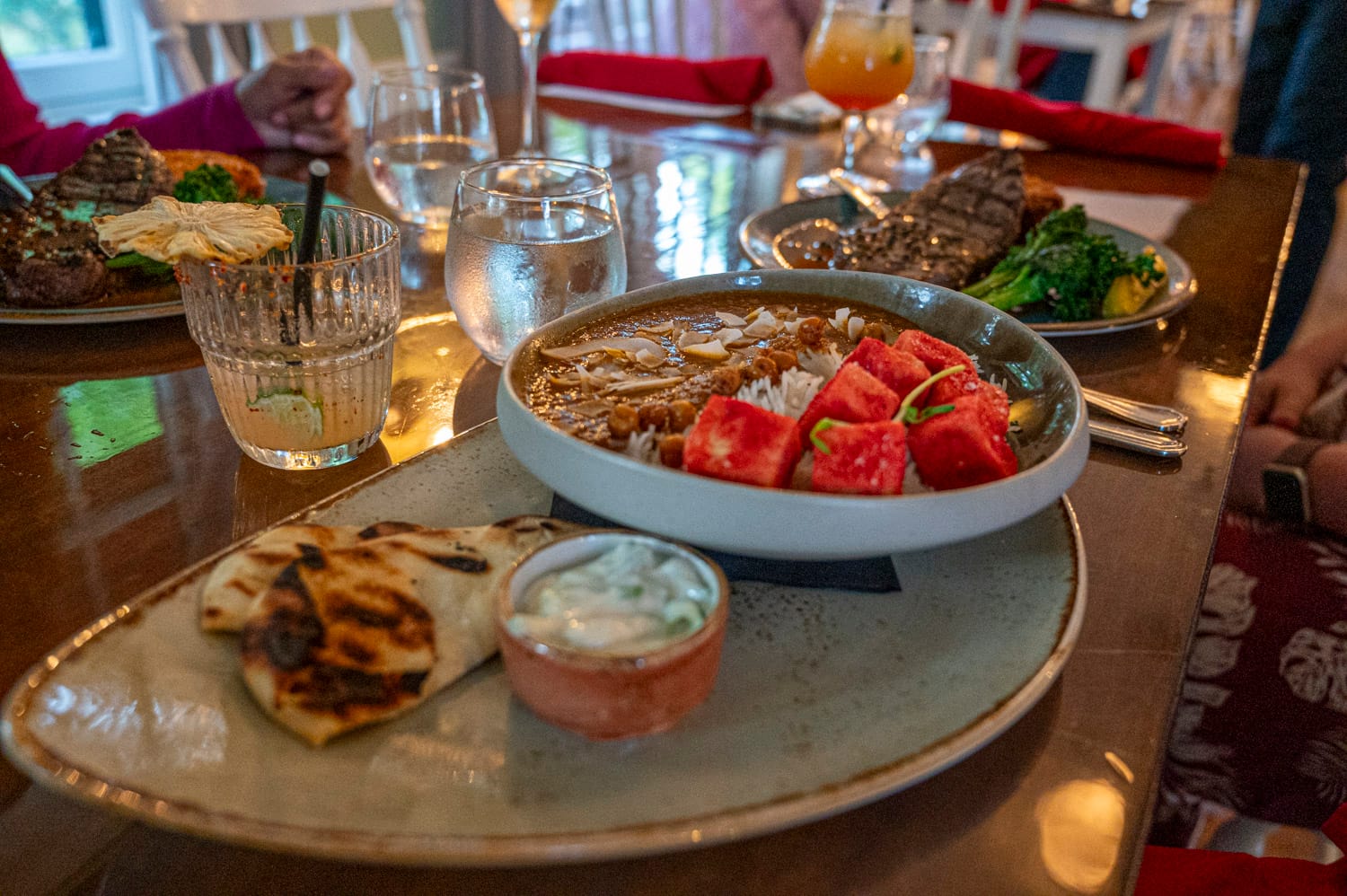 food at the opinicon, a curry meal and a steak in the background