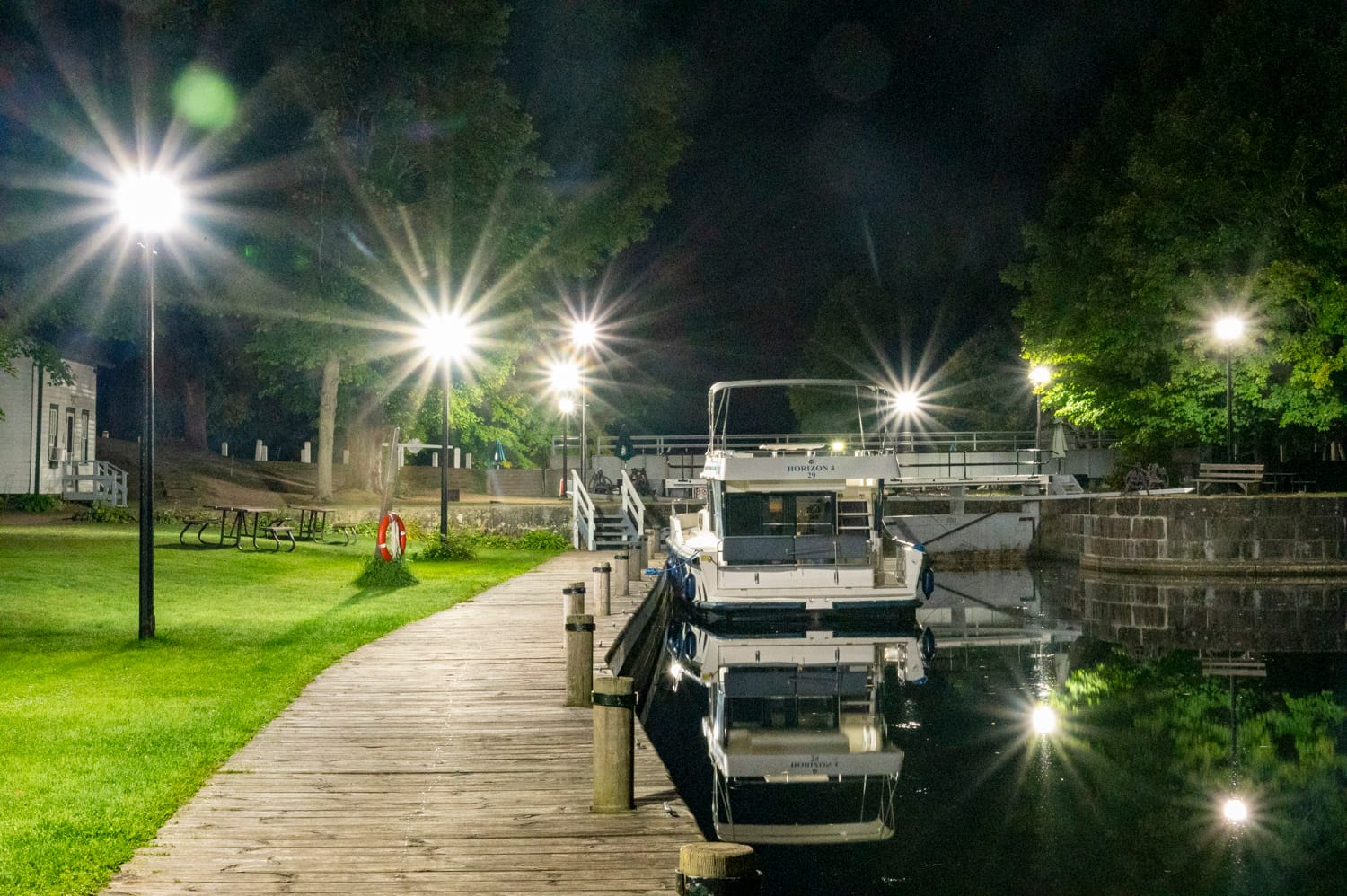 night photo of a le boat houseboat docked at chaffey's lockstation