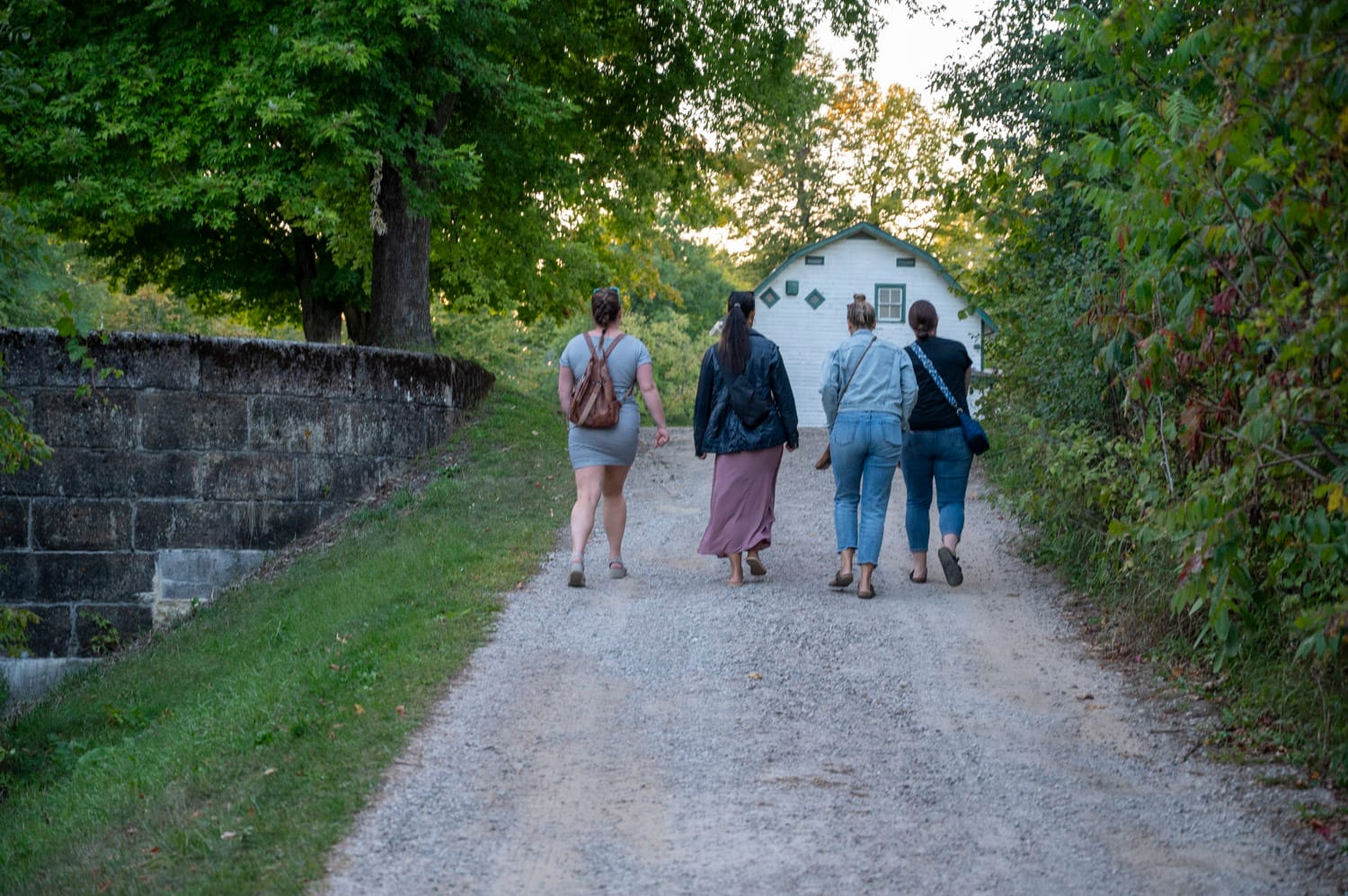 four women walking towards the Upper Beveridges Lockstation, part of the Rideau Canal National Historic Site