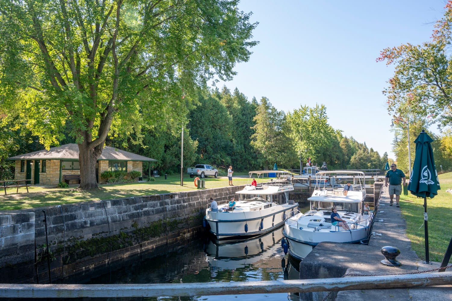 two le boat houseboats inside a lock on the rideau canal