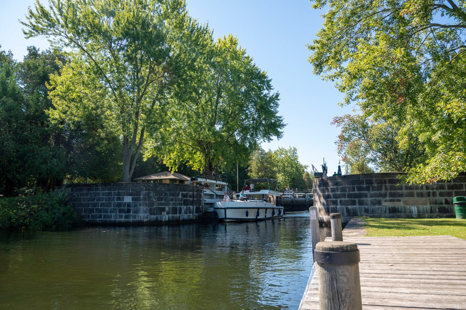 a le boat houseboat is coming out of a lock