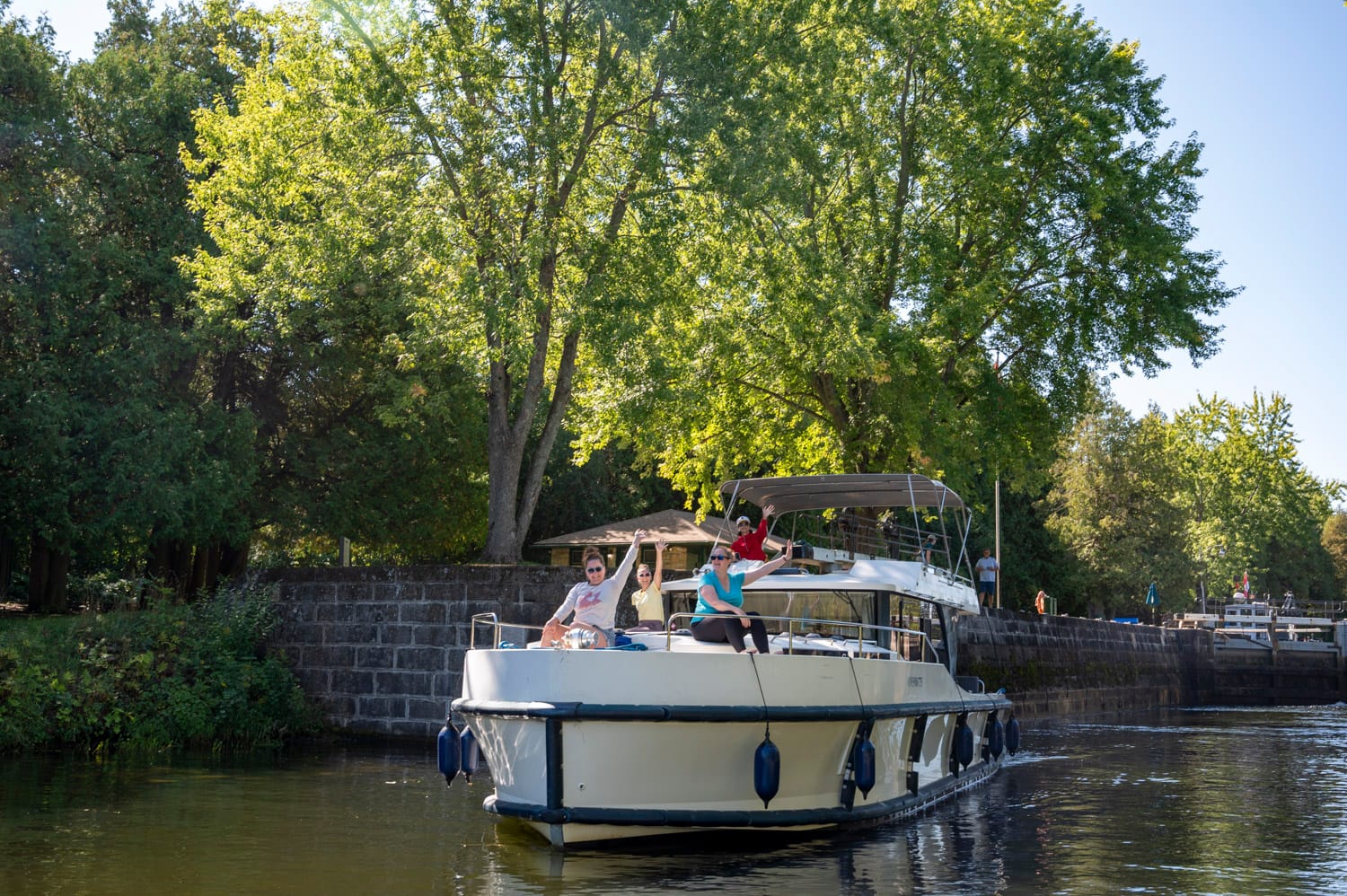 front of a le boat houseboat as it exits a lock on the rideau canal