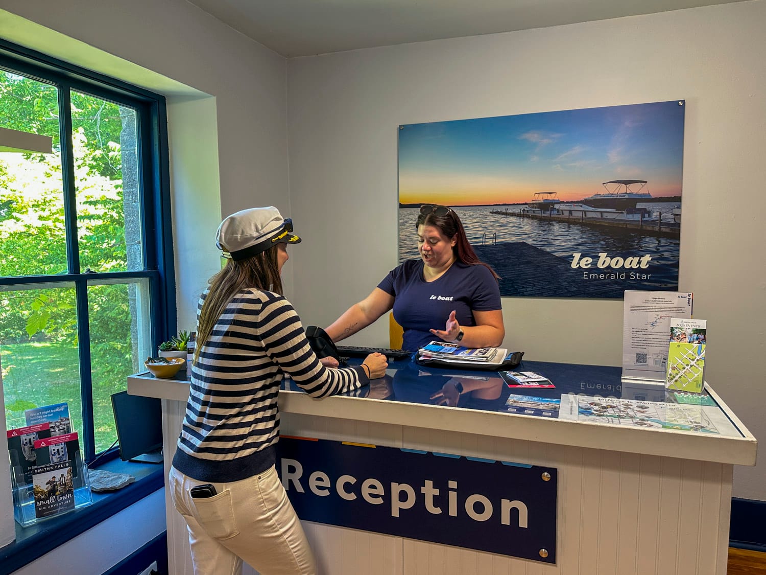 a woman checks in at the le boat reception desk