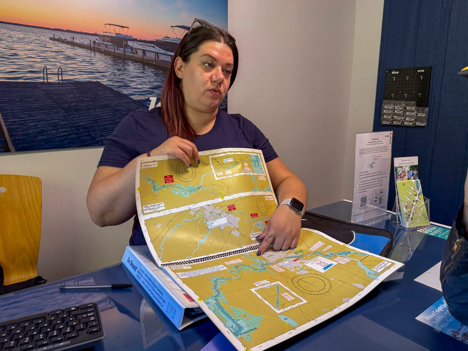 a le boat staff member is showing a guest the orientation map book