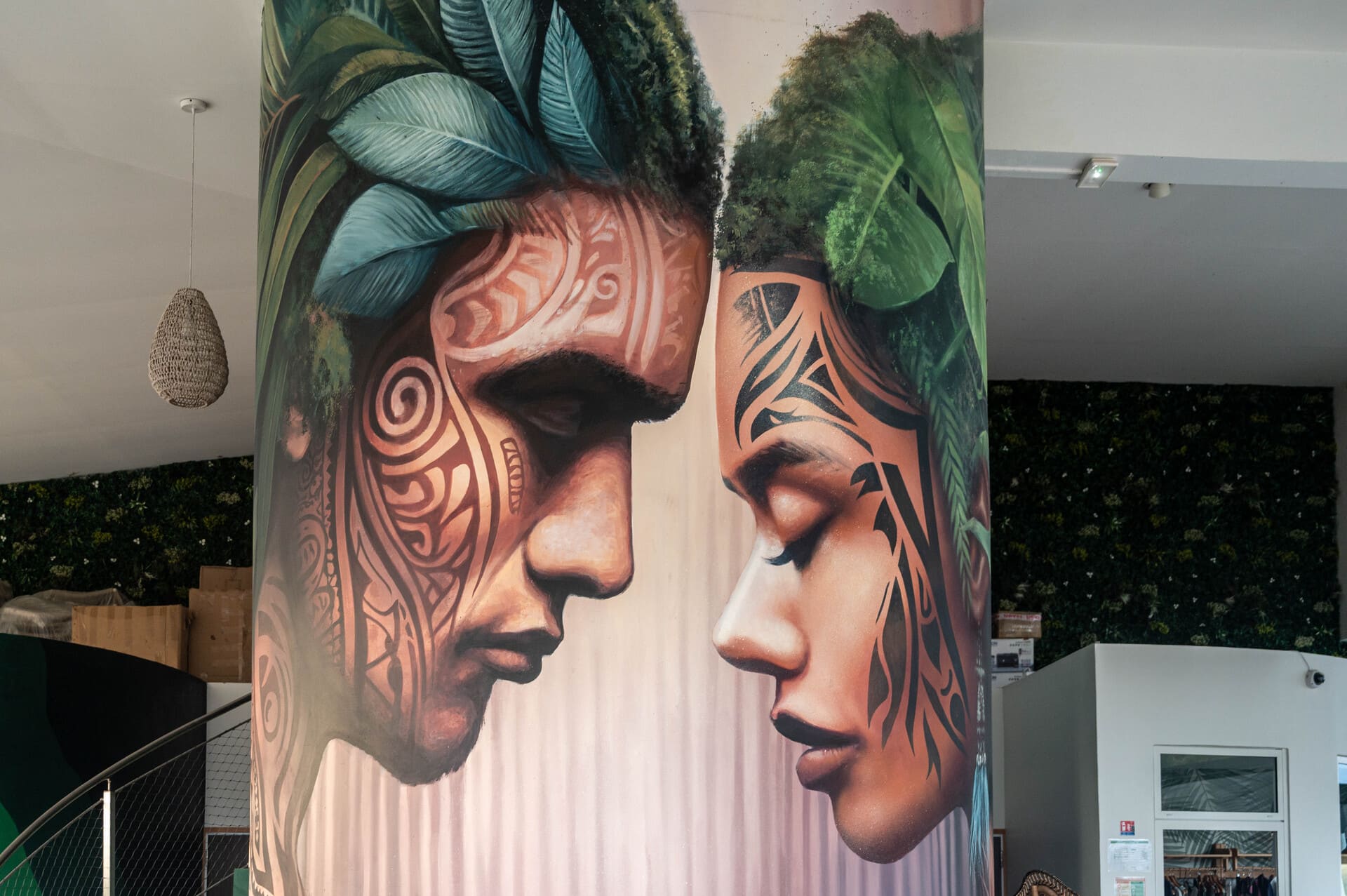 Stunning mural at Apatoa Raiatea by Graff-mat depicts a French Polynesian couple, leaning into each other, not touching, but deeply connecting
