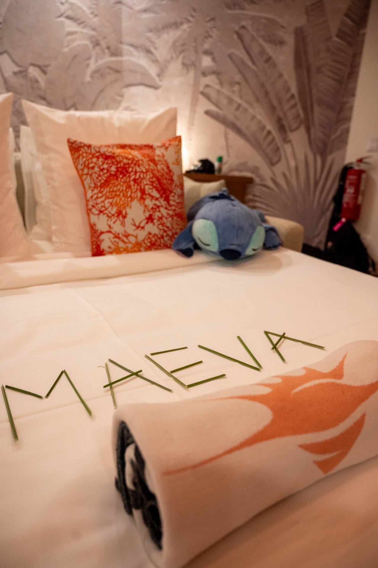 Inside the Apatoa Raiateta Luxury Villas - a king-size bed with beautiful, rich linens, and a custom mural by Tahtian Artist, Jops, to center it all with a spirit of “Maeva”