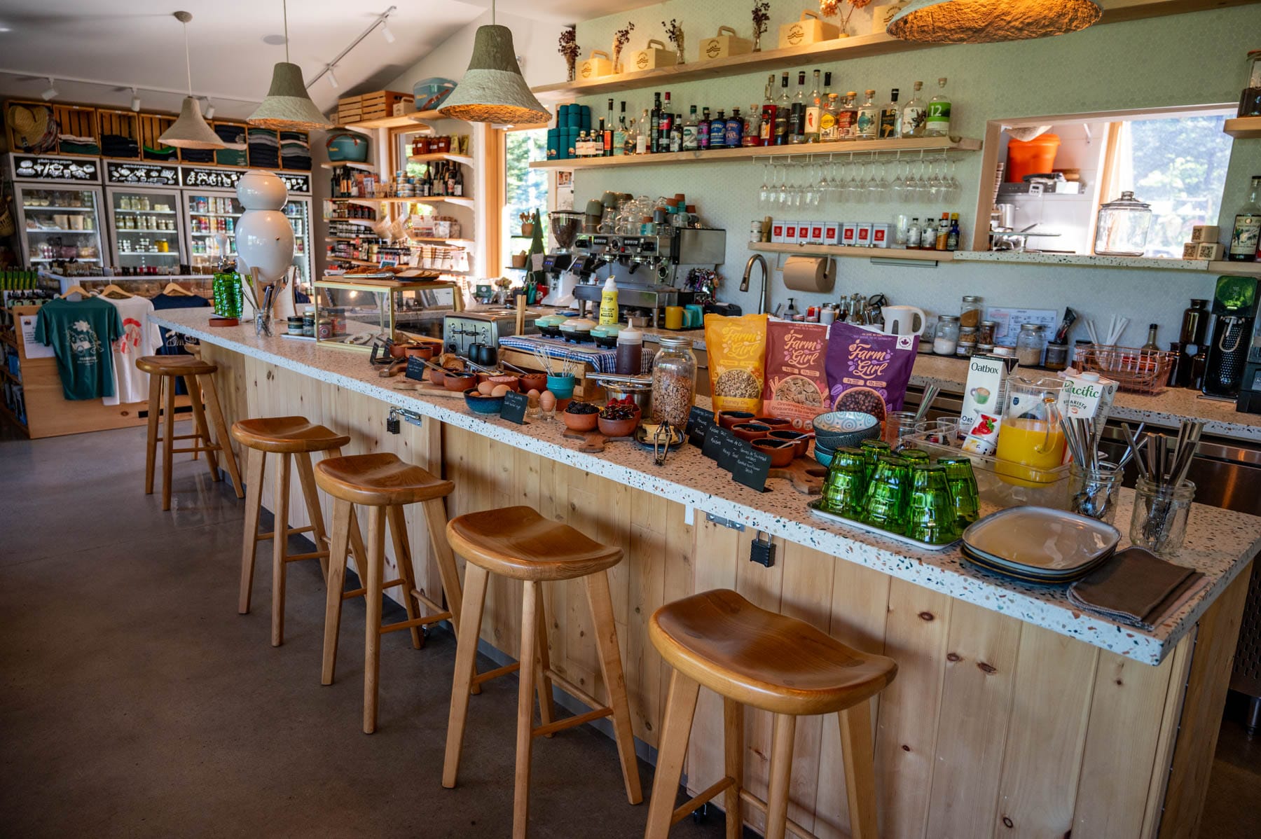 indoor buffet at La Buvette, Farouche Tremblant, with breakfast bar, granola, eggs, juice, spirits, and bar stools