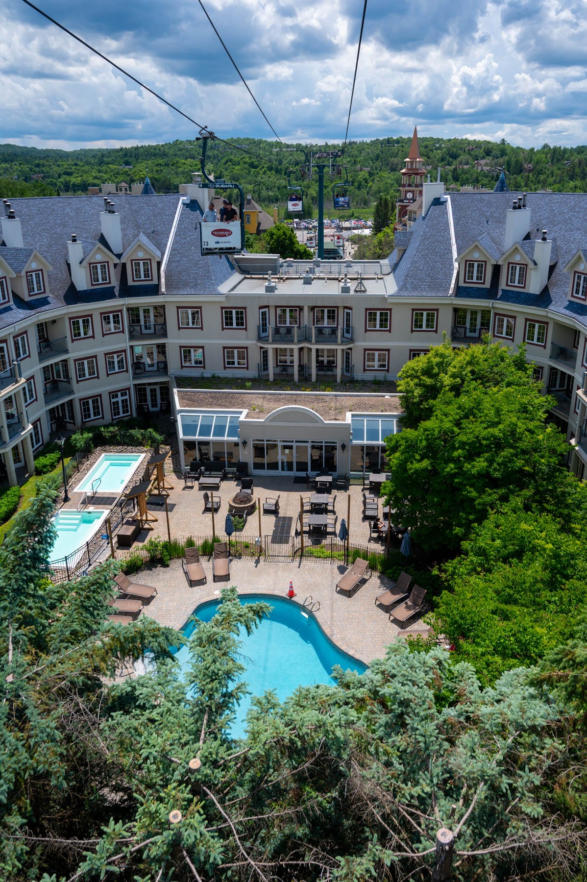 Hotel with pools, hot tub, outdoor dining, gondola, and mountain views at Marriott Residence Inn Tremblant