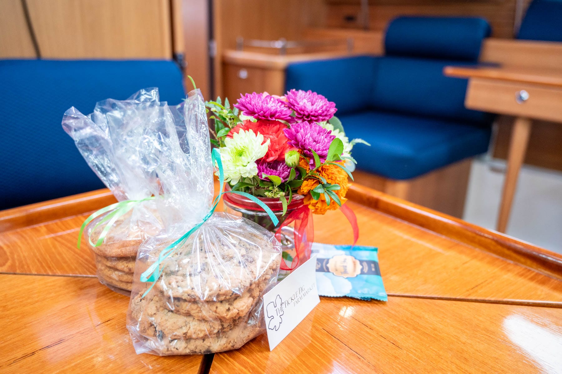 a small vase of boat-friendly flowers, a box of cookies from The Fickle Fig, a bakery in Sidney, with gluten-free options included