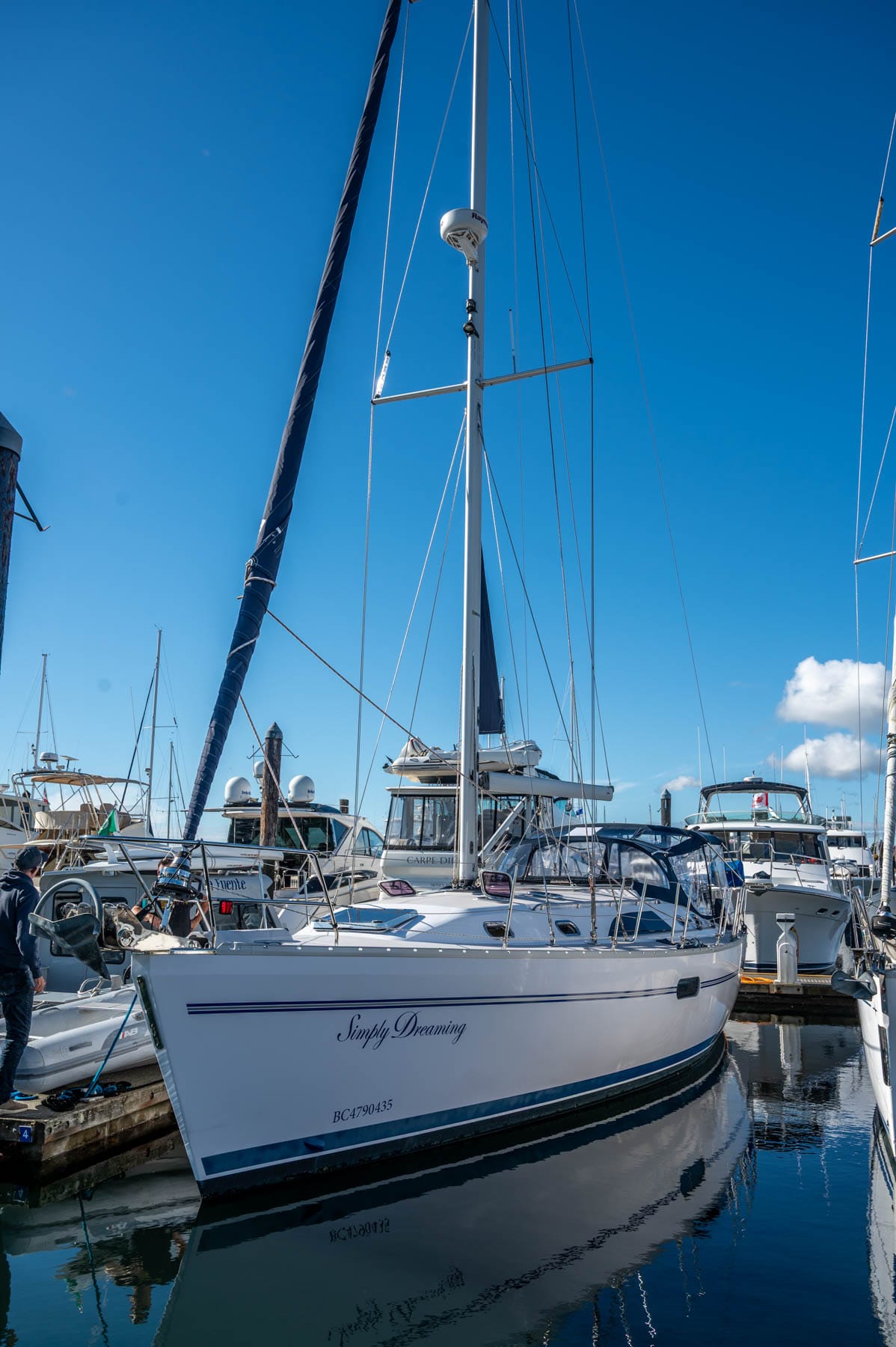 Sailing Charter in Victoria - white sailboat "Simply Dreaming" docked in a marina with other boats under a blue sky
