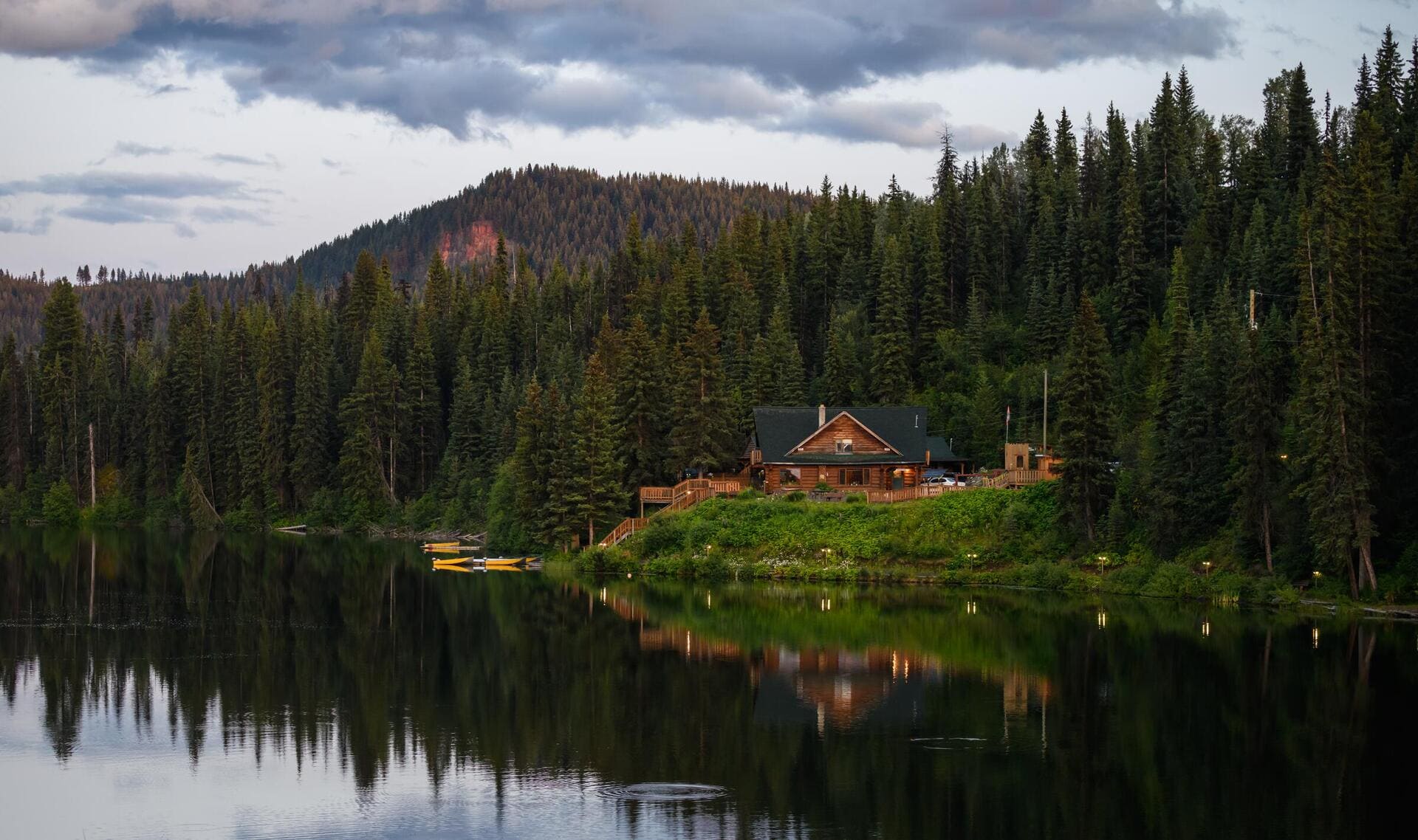 wooden cabin nestled by the water at Lac des Roches Resort along Highway 24 in Bridge Lake, British Columbia, Canada