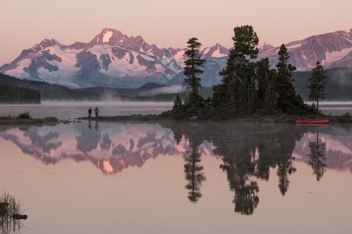 serene sunrise view shows Whitton Lake in the Nuk Tessli Wilderness Experience region of British Columbia, Canada