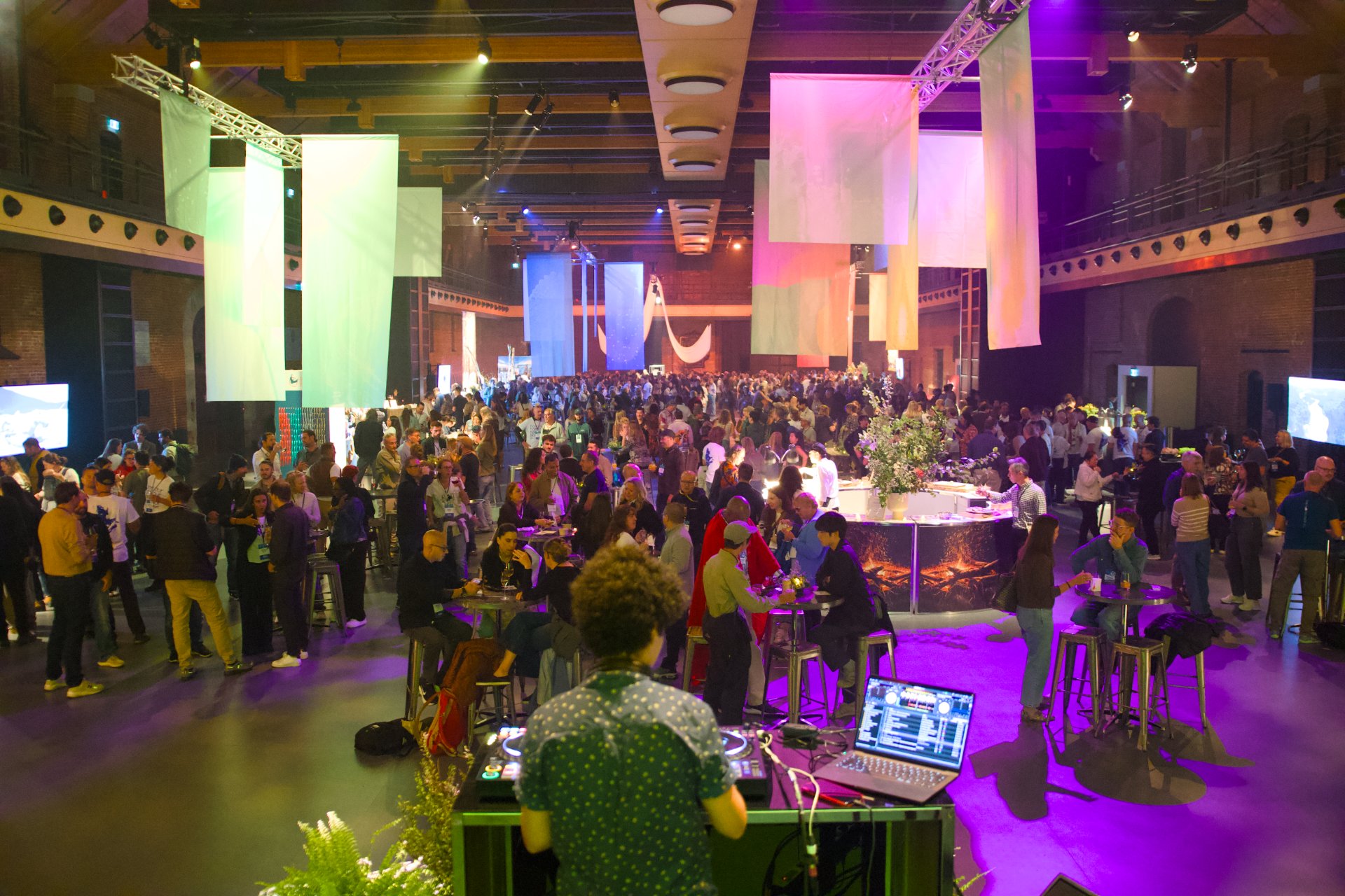 ATWS 2026 Qu&eacute;bec - an indoor corporate party featuring a DJ booth in the foreground and a large crowd mingling around high cocktail tables